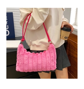 Detail of pink tie-dye plush shoulder bag with textured faux fur and slim leather strap