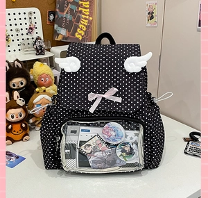 Detail of cute polka dot ita bag with clear PVC pocket and plush wings decoration