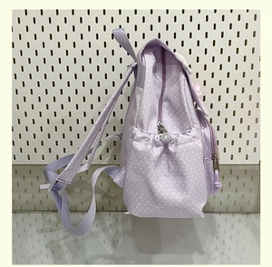 Side view of cute purple polka dot backpack showing elastic water bottle pocket detail