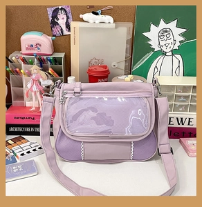 Detail of lavender Ita bag with large clear PVC window for badge display on a desktop