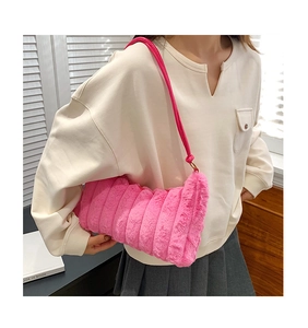 Detail of hot pink plush tote bag with wide vertical quilting and faux fur texture
