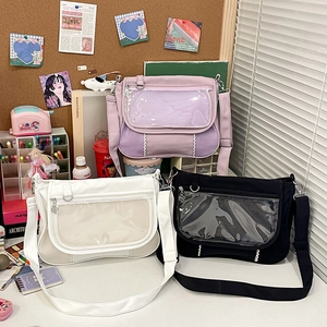 Three Ita bags in purple, white, and black with clear display windows and flower charms