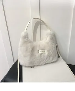 Detail of soft white faux fur shoulder bag featuring an embroidered Love Every Day patch