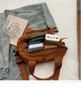 Detailed view of spacious interior of brown nylon tote bag with daily essentials inside