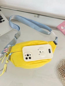 Detail der gelben Bauchtasche aus Segeltuch zeigt den Stauraum mit einem Smartphone