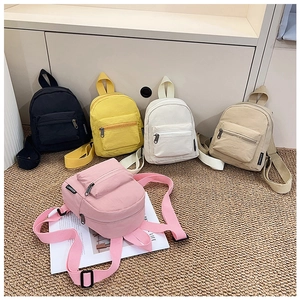Five assorted colors of mini nylon backpacks including yellow, pink, and khaki