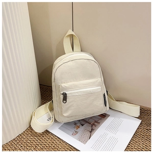 Detail view of cream white nylon mini backpack with high-quality zipper and woven strap