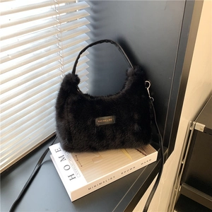 Chic black faux fur hobo bag with love every day tag and minimalist shoulder strap