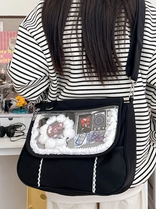 Black Ita-bag featuring a clear PVC window with white ruffles and adjustable strap