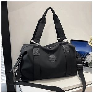 Detail of black waterproof travel bag with reinforced handles and removable shoulder strap