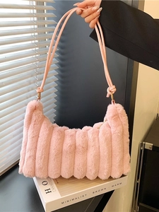 Pink tie-dye plush shoulder bag with vertical stripe texture and gold ring straps