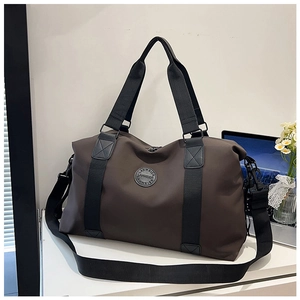 Close-up of the large capacity dark brown travel bag with durable handles and logo