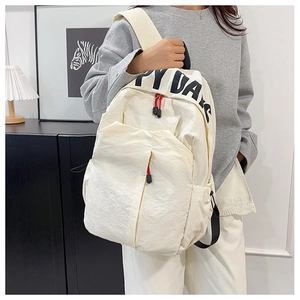 Detail of off-white nylon backpack with Happy Days print and red zipper puller accent