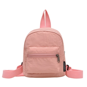 Pink minimalist nylon mini backpack for women with front zipper pocket and sleek design