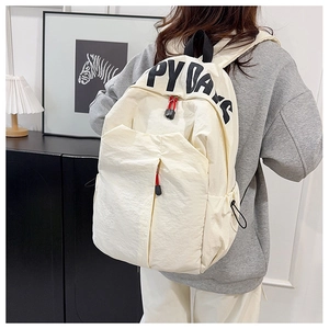 Detail of off-white nylon backpack featuring Happy Days text and red zipper pulls