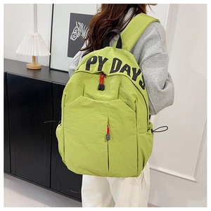 Detail view of large green nylon backpack with happy days print and red zipper pull