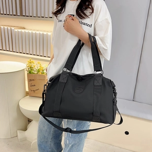 Large capacity black travel bag for women with adjustable strap and dual handles