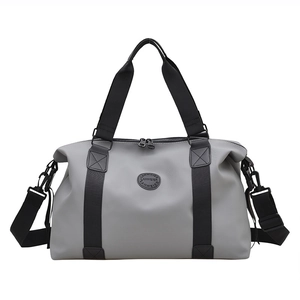 Gray large capacity travel bag with top handles and adjustable shoulder strap on white backdrop