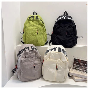 Four colors of nylon backpacks with Happy Days print on a clean white display stand