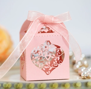 Pink laser-cut wedding favor box with heart pattern and elegant organza ribbon bow