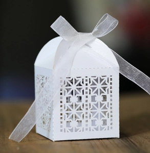 White laser cut wedding candy box with geometric pattern and white organza ribbon bow