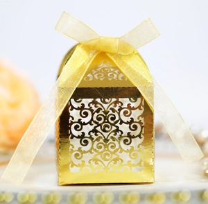 Elegant gold hollow laser-cut gift box with yellow organza ribbon for wedding candy