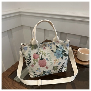 Detail of floral jacquard tote bag with tulip pattern and adjustable fabric strap