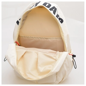 Minimalist beige nylon backpack showing large interior main compartment and inner pocket