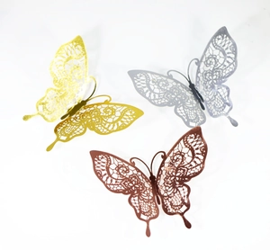Macro detail of 3D hollow butterfly wall stickers in gold, silver, and bronze metal tones