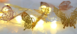 Detailed view of hollow lace rose gold butterfly stickers with warm LED fairy lights decor
