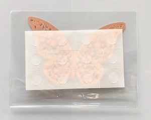 Detail of rose gold 3D hollow paper butterflies with adhesive glue dots for wall decor