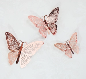 Detailed macro view of 3D hollow rose gold butterfly wall stickers with intricate texture