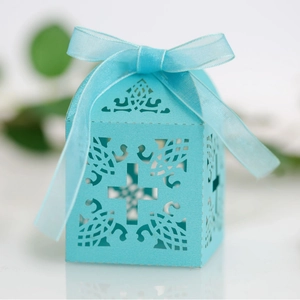 Light blue laser-cut hollow candy gift box with cross pattern and silk ribbon bow