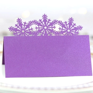 Purple laser-cut snowflake place cards for Christmas weddings and winter events