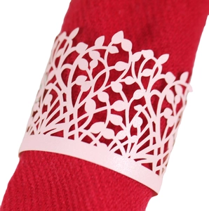 Pink laser-cut pearl paper napkin ring featuring intricate leaf and vine patterns