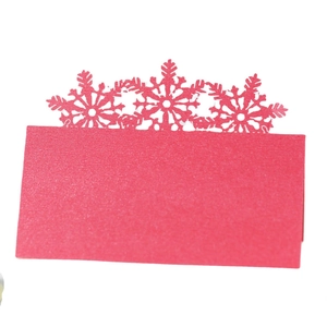 Sparkly red snowflake laser cut place card with a foldable design for holiday tables