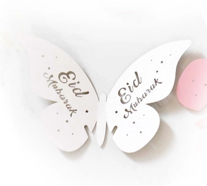 White butterfly paper place card with Eid Mubarak print for festive table decor