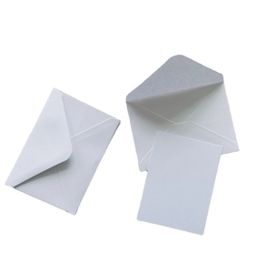 Detail of minimalist light grey stationery set with two envelopes and a blank paper card