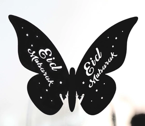 Detailed view of Eid Mubarak butterfly glass cards with white lettering on black cardstock