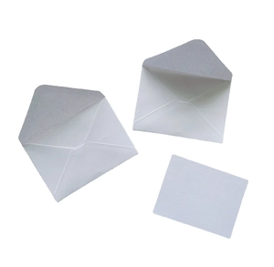 Macro shot of two premium white pearlescent paper envelopes with matching square gift card
