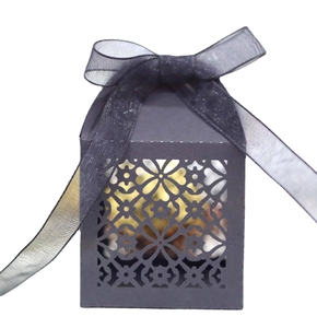 Elegant black laser-cut floral gift box with a sheer chiffon ribbon and gold chocolates