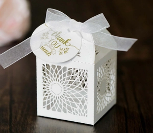Elegant white laser-cut hollow candy box with silk ribbon and gold Thank You tag