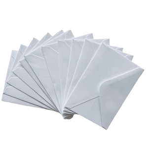 Set of premium white paper envelopes with V-flap design fanned out on white surface