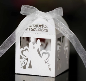 Detailed laser cut heart pattern and bride and groom silhouette on white favor box