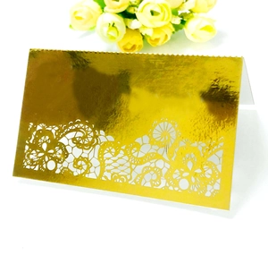 Elegant gold laser-cut hollow place card with floral lace design for wedding banquet table
