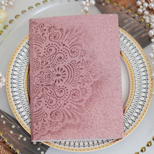 Pink glitter laser-cut wedding invitation card with mandala pattern on vintage plate