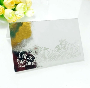 Detailed laser cut silver mirror place card with elegant lace pattern for wedding decor