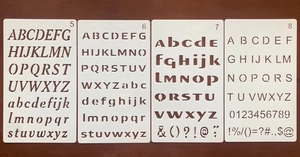 Detail showing a set of 4 white PET alphabet and number stencils for creative DIY painting