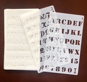 Detail view of semi-transparent PET letter and number stencils for DIY art painting