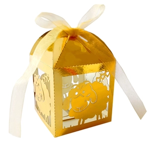 Golden laser cut candy box featuring a cartoon sheep design and a white ribbon bow